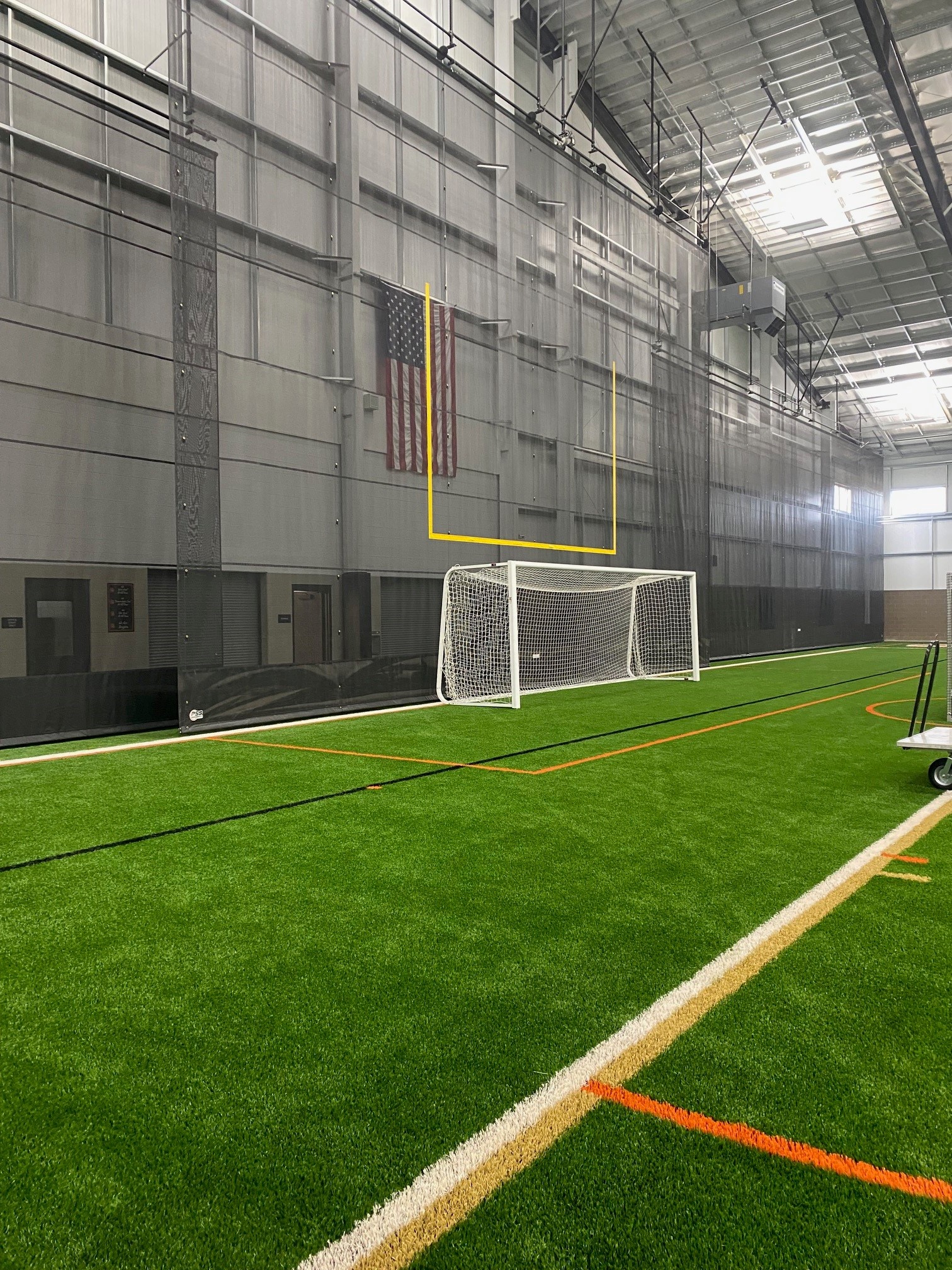 Full-height mesh divider curtain — Brighton indoor practice facility